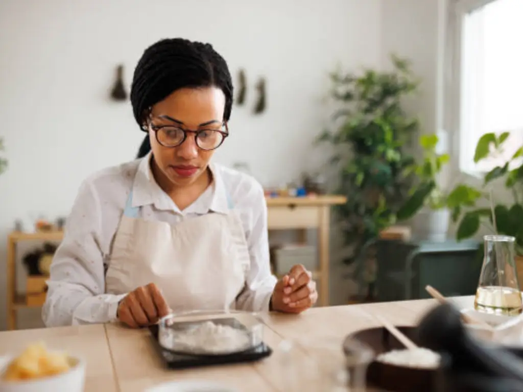 A woman weighing zeolite powder